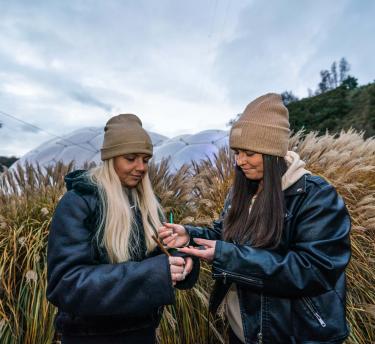 Teachers writing and dressed warmly outside at the Eden Project